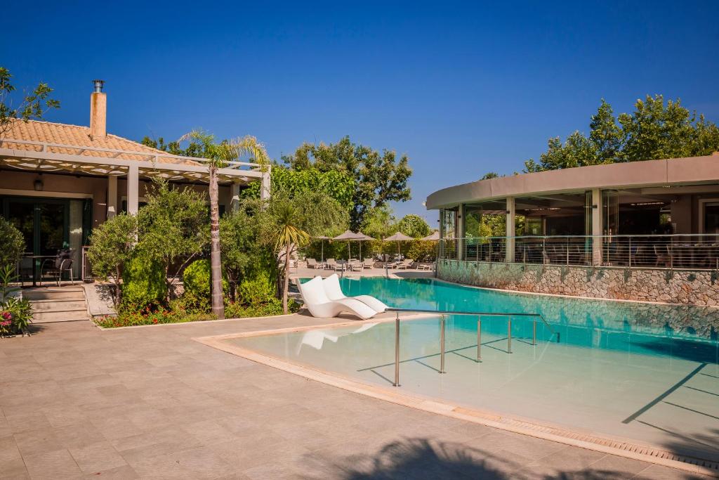 a house with a swimming pool next to a building at Daluz Boutique Hotel in Preveza