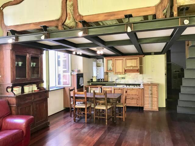 a kitchen with a table and chairs in a room at Prione in Genoa