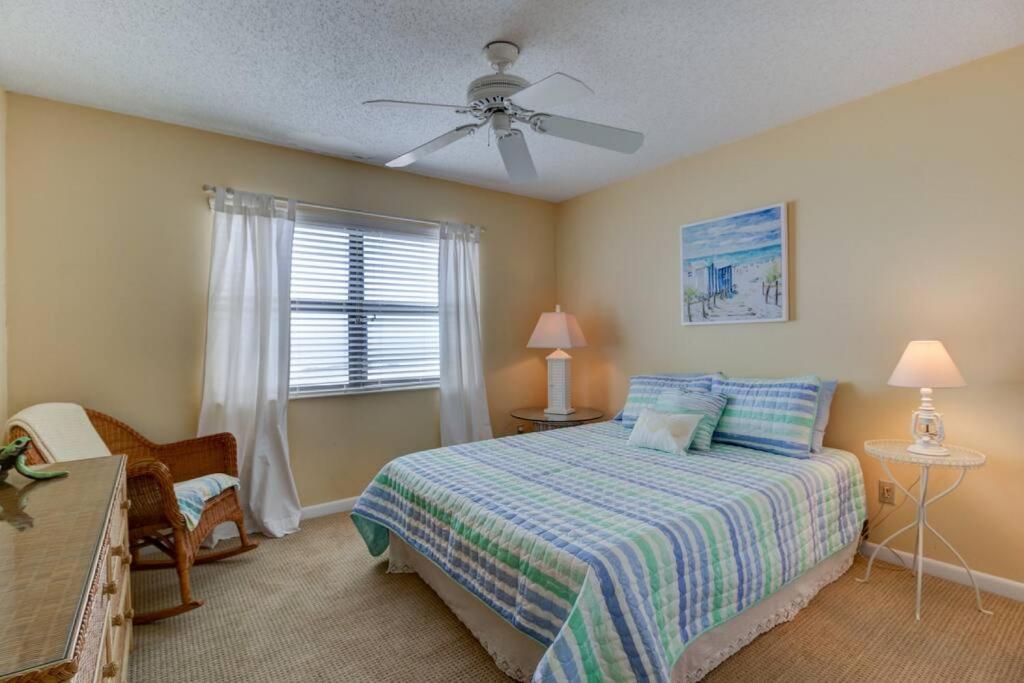 a bedroom with a bed and a ceiling fan at Tipsy Turtle Direct Oceanfront in Palm Coast