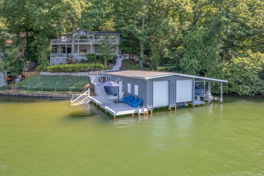 an aerial view of a house on a dock in the water at Lake Al'Lure in Lake Lure