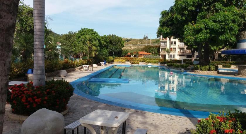 a large blue swimming pool in a resort at VILLAS DEL PALMAR APTO 406 in Santa Marta