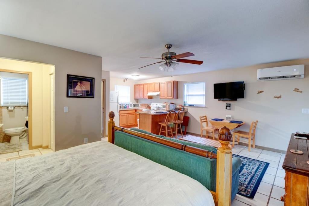a bedroom with a bed and a kitchen with a table at Good Old Days Cottage King Bed Pet Friendly in Daytona Beach