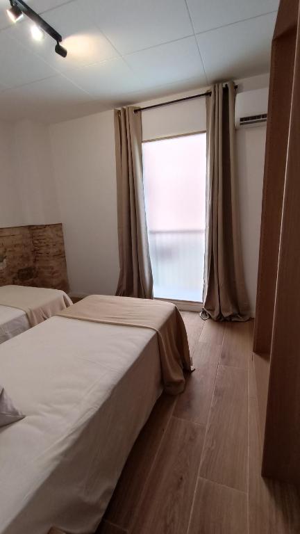 Postel nebo postele na pokoji v ubytování BOUTIQUE Apartment AVE Centro Lleida