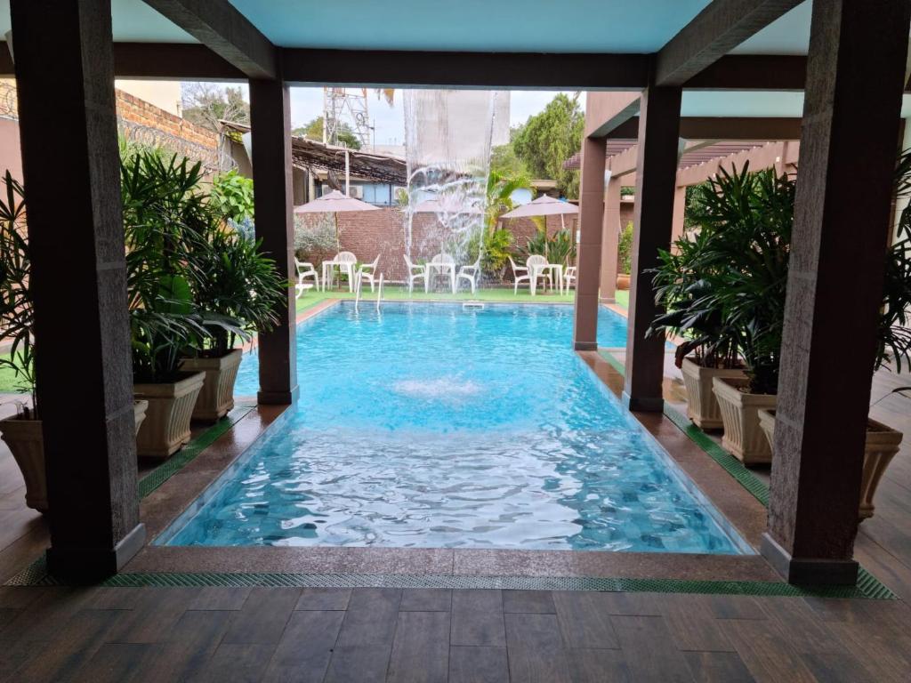 a swimming pool in the middle of a building at Hotel Rouver in Foz do Iguaçu