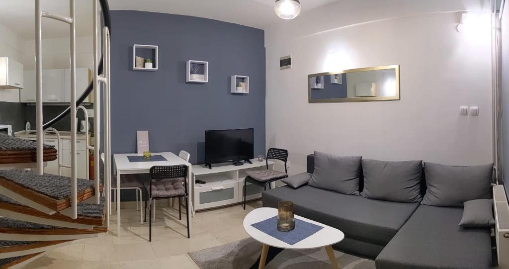 a living room with a couch and a table at Apartman Mia in Slavonski Brod
