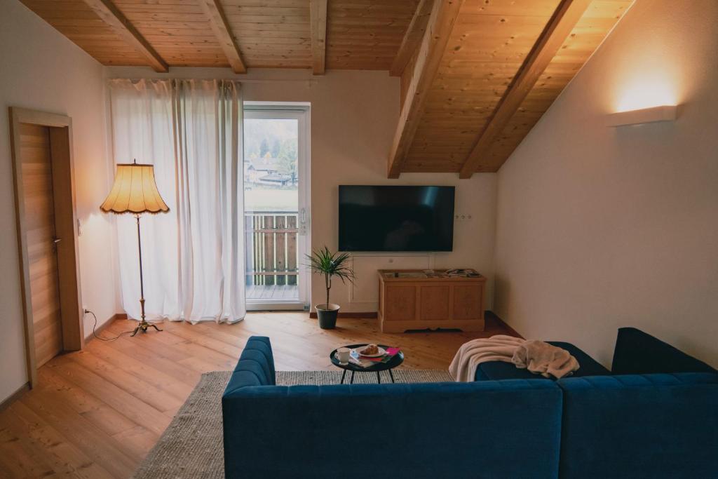 a living room with a blue couch and a television at 164 apt. in Val di Vizze