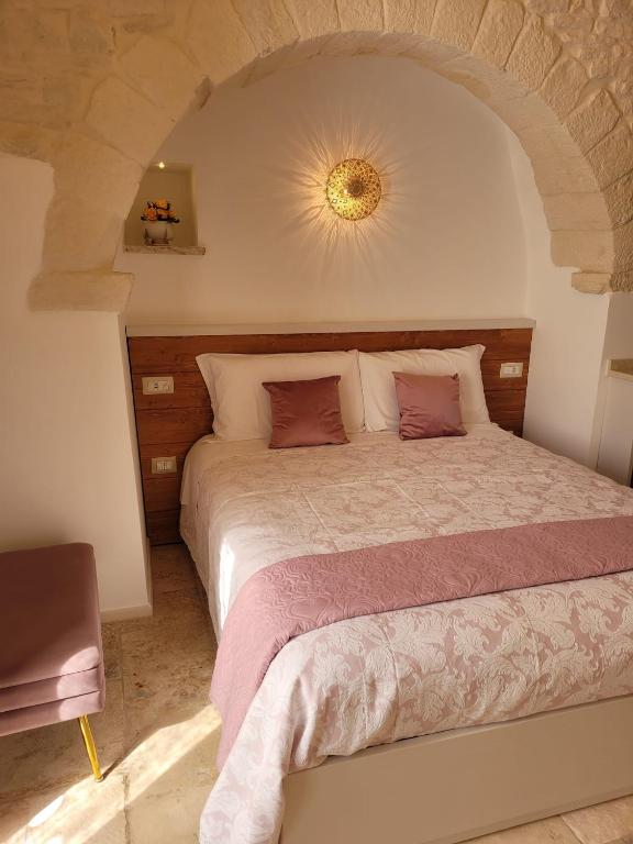 a bedroom with a large bed in a room at TRULLI MATRICE in Alberobello