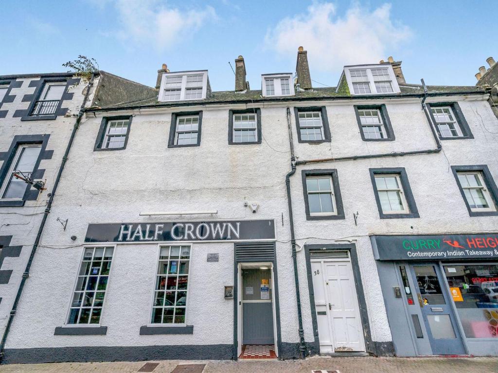 a large white building with a hair growth store at Bay View - Uk38589 in Inverkeithing