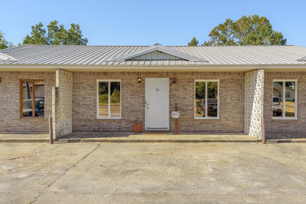 a brick house with a white door at Unit 19 Green Acres Apartment in Enterprise