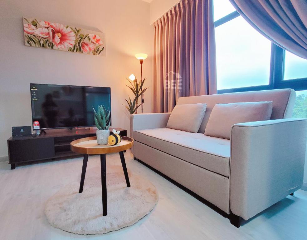 a living room with a couch and a table at Bee Homestay - Jesselton Quay Kota Kinabalu in Kota Kinabalu