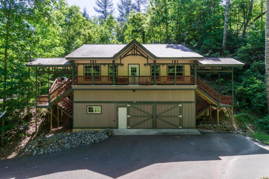 a house with a large deck and a garage at New Listing! Bavarian Cabin - 2 Bedrooms, 8 Minutes to Dahlonega, Hot Tub, Game Room in Dahlonega