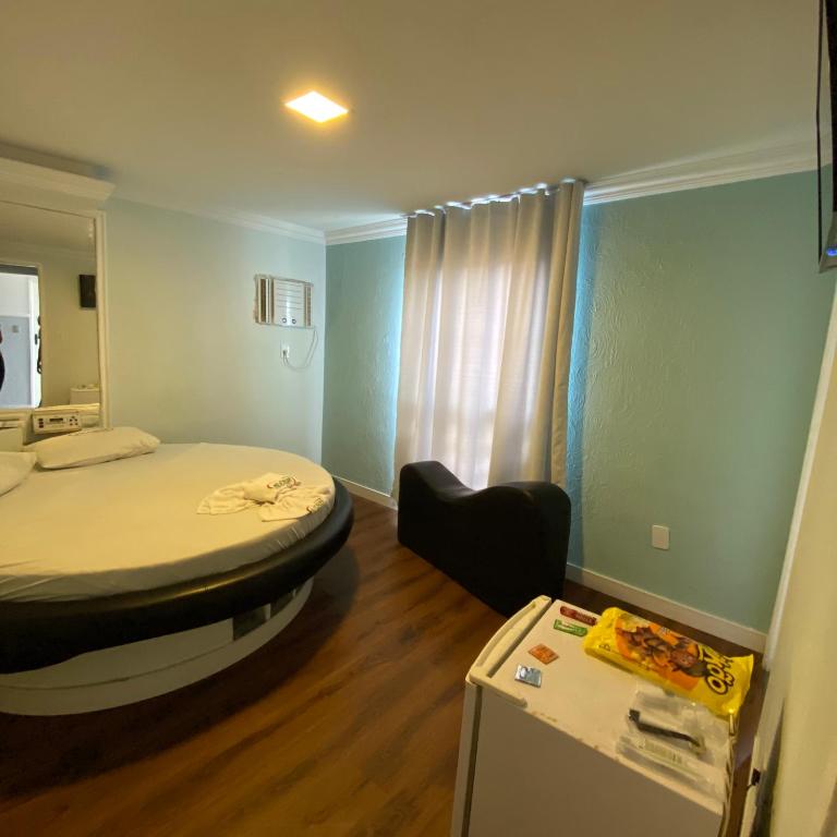 Postel nebo postele na pokoji v ubytování Hotel Milenium Itapuã