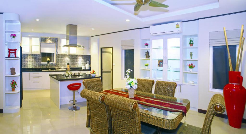 a kitchen with a table and chairs in a room at Samui Sunrise Seaview Villa in Chaweng