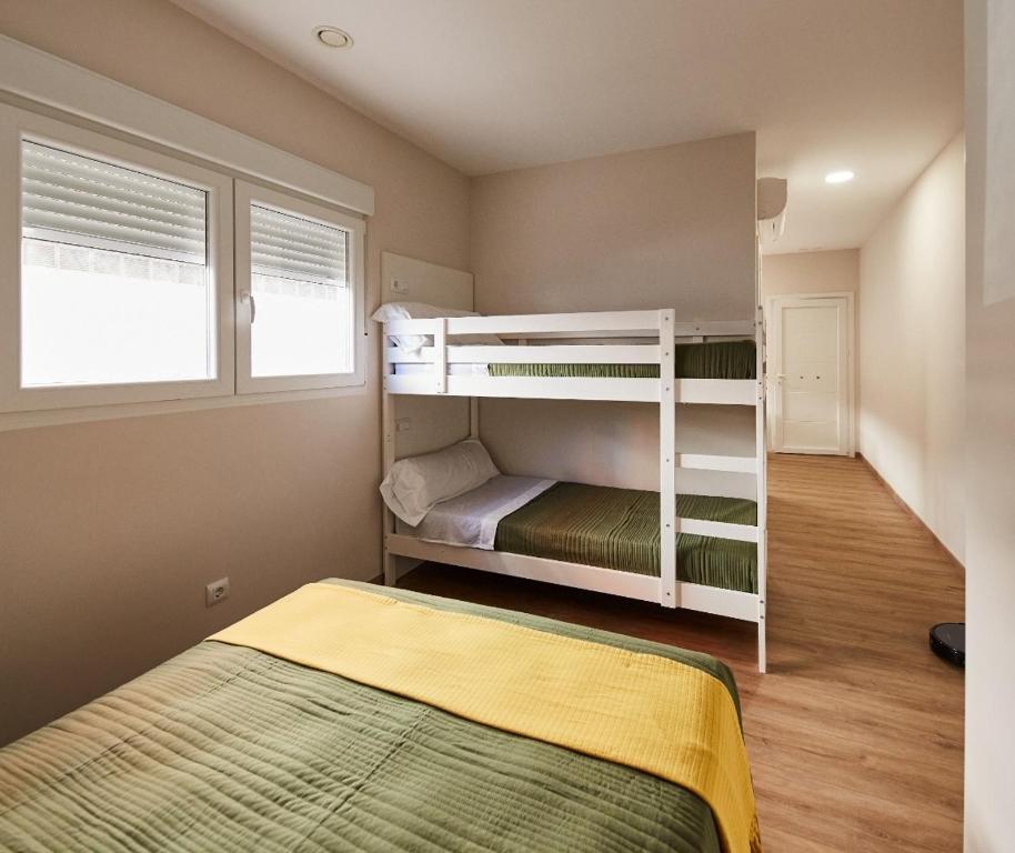 西圭伊羅的住宿－A Estreliña，一间卧室配有两张双层床和一张床