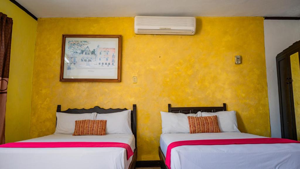 Postel nebo postele na pokoji v ubytování Hotel Mucuy