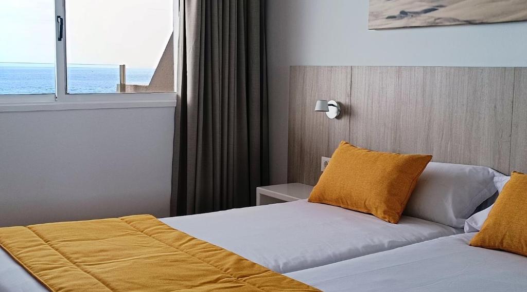 A bed or beds in a room at Marina Elite