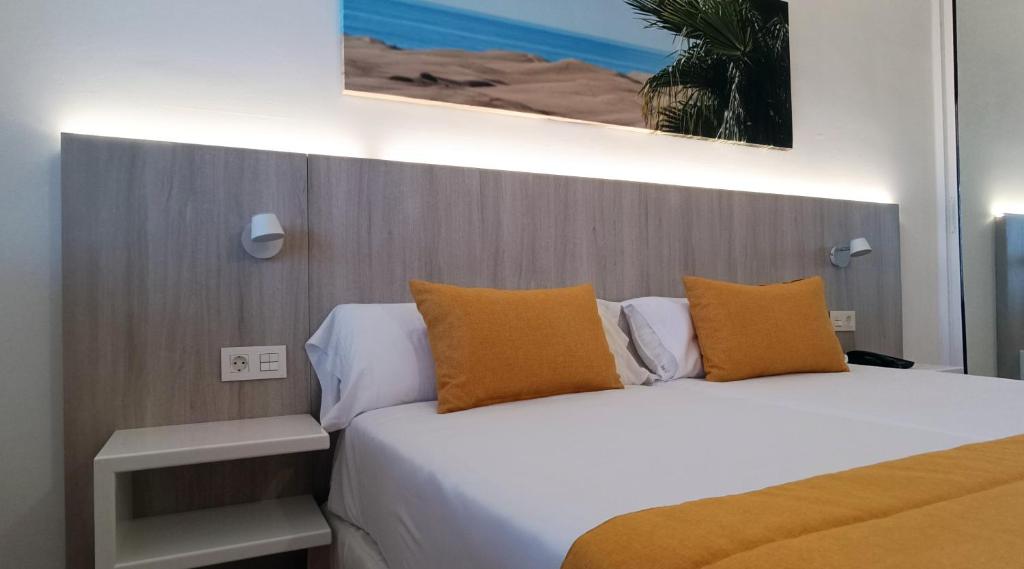A bed or beds in a room at Marina Elite