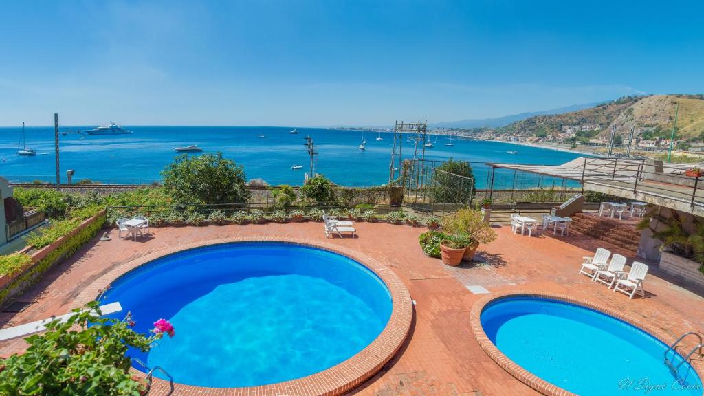 a swimming pool with a view of the ocean at Il Signò Cocco mare apartment in Taormina