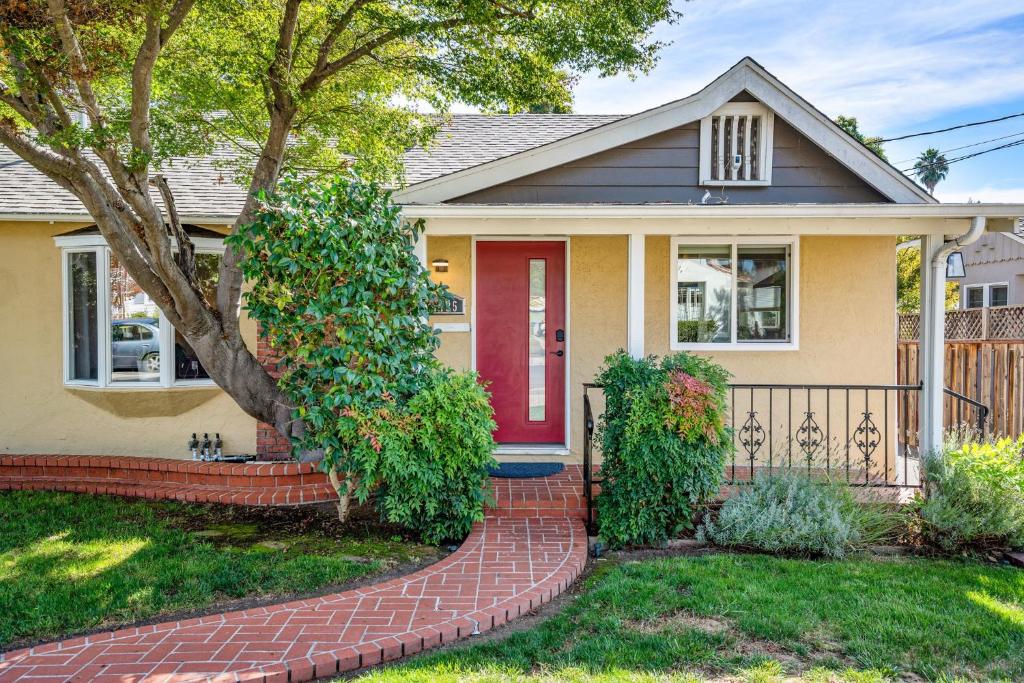 a house with a red door and a brick walkway at with Heated Pool & Hot Tub! 3BR Napa Staycation Home home in Napa