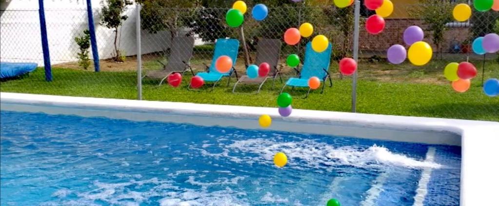 a pool with colorful balls in a yard at Mis Princesas en casa in Chiclana de la Frontera
