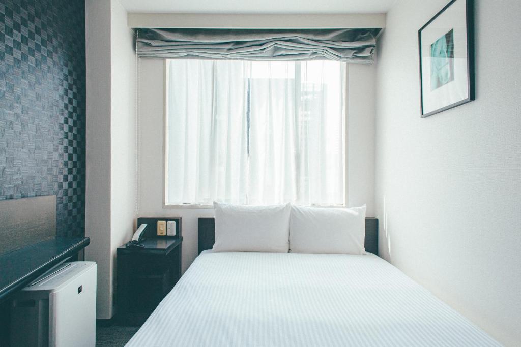 Postel nebo postele na pokoji v ubytování Hamilton Hotel Black