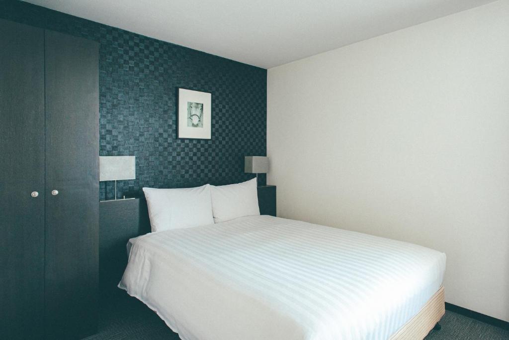 Postel nebo postele na pokoji v ubytování Hamilton Hotel Black