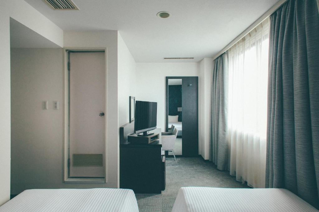Postel nebo postele na pokoji v ubytování Hamilton Hotel Black
