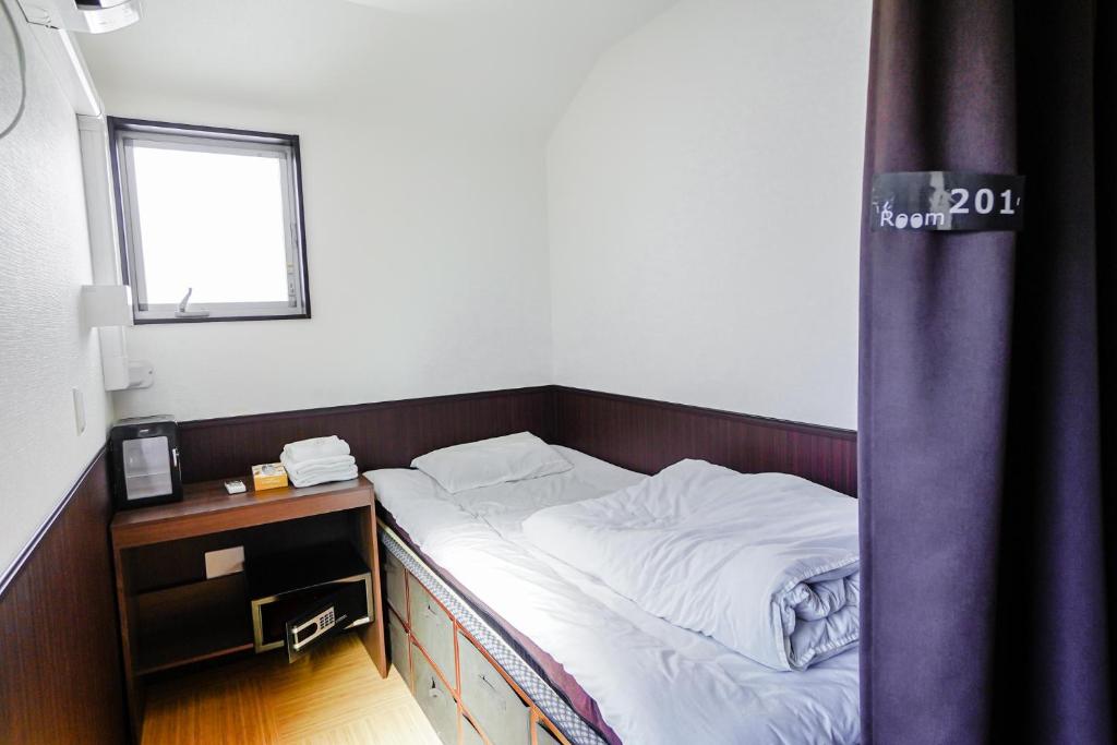Postel nebo postele na pokoji v ubytování SAMURAI STAY 洗足池-male only 男性専用