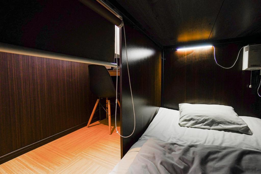 Postel nebo postele na pokoji v ubytování SAMURAI STAY 洗足池-male only 男性専用