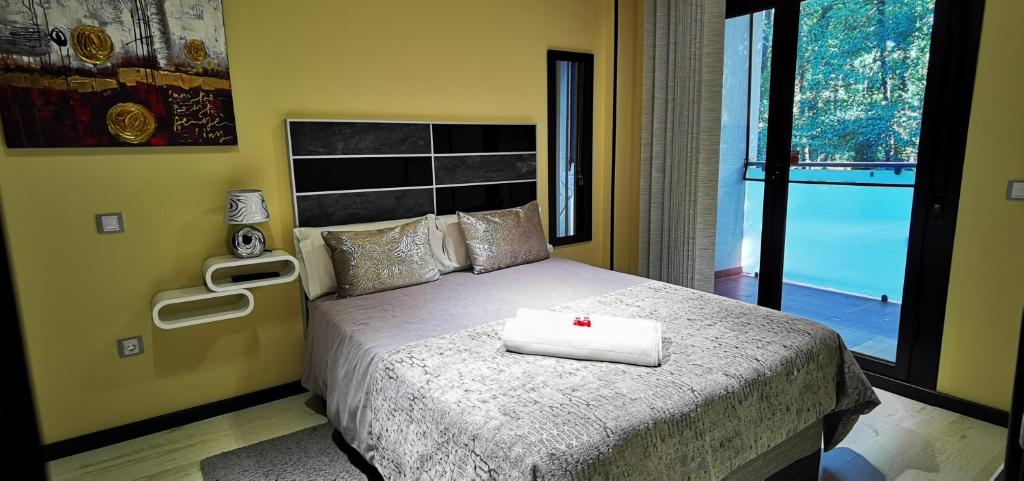 a bedroom with a bed with a cross on it at APARTAMENTO ALES in Arenas de San Pedro