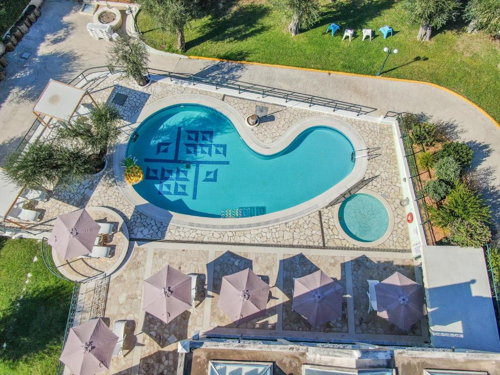 an overhead view of a swimming pool with umbrellas at St Nicholas B6 Beach Garden View ii in Dafnila
