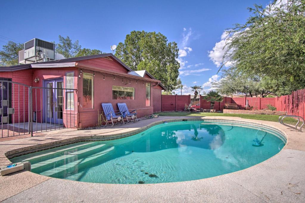 a small swimming pool in front of a red house at Stylish Tucson Home Backyard Oasis with Grill! in Tucson