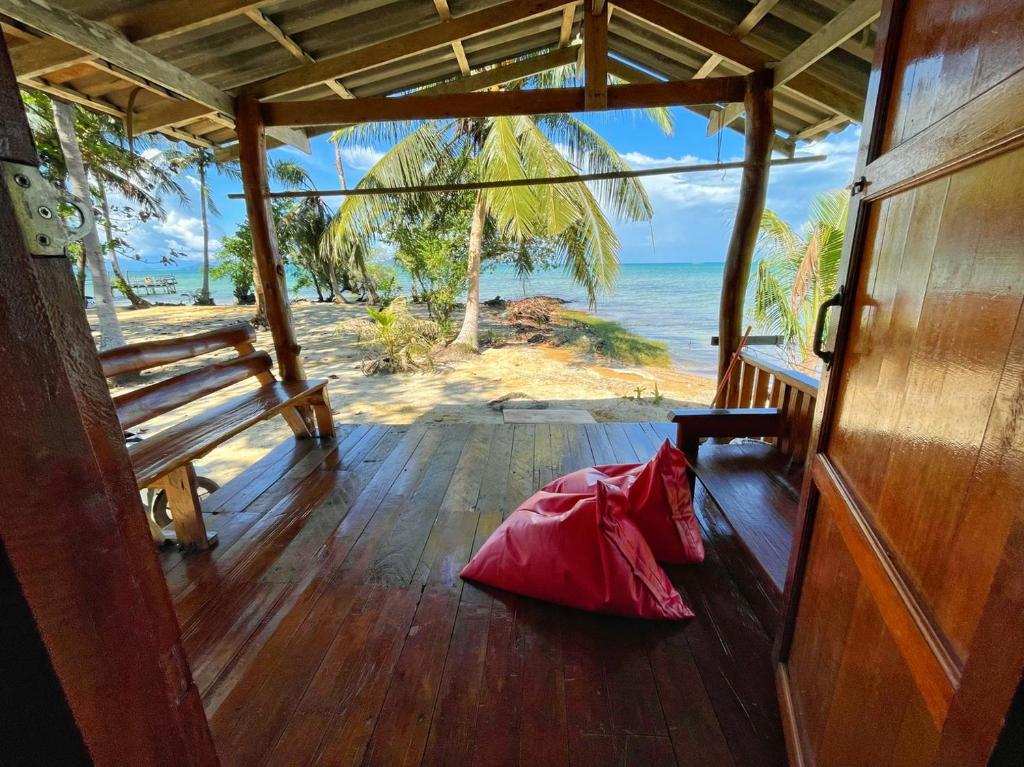 a red pillow on the floor of a room with a beach at Koh Mak Green View Resort in Ko Mak