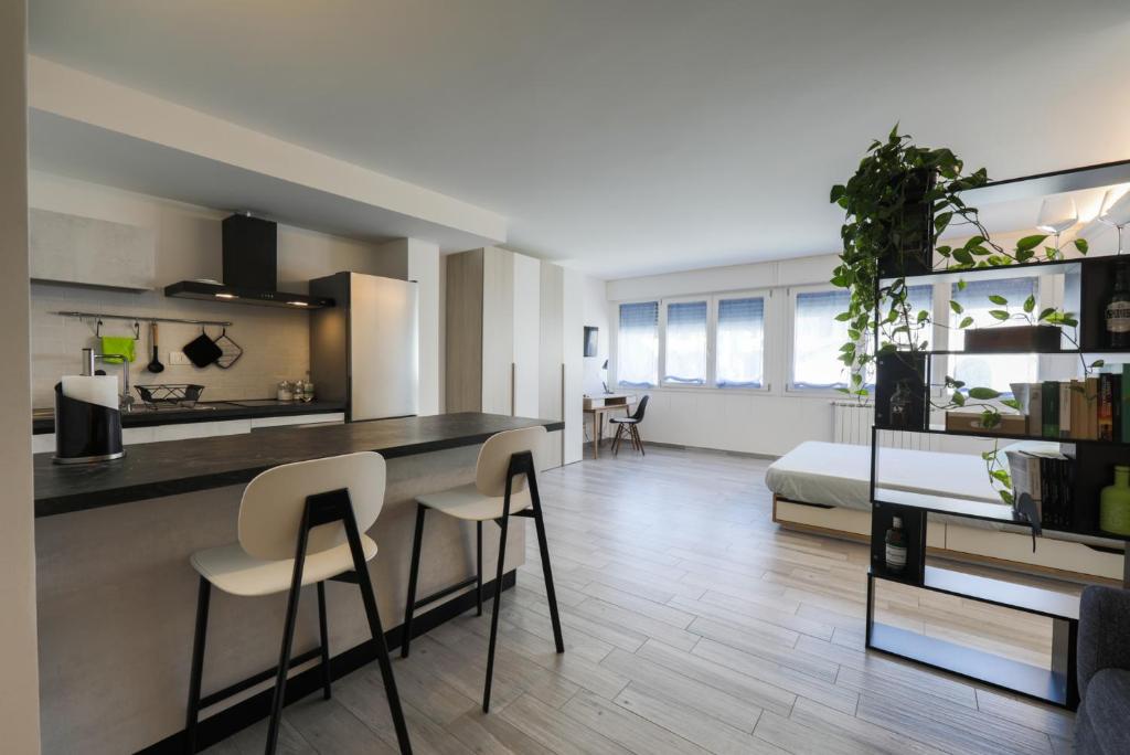 a kitchen and living room with a table and chairs at Cesar's House in Florence