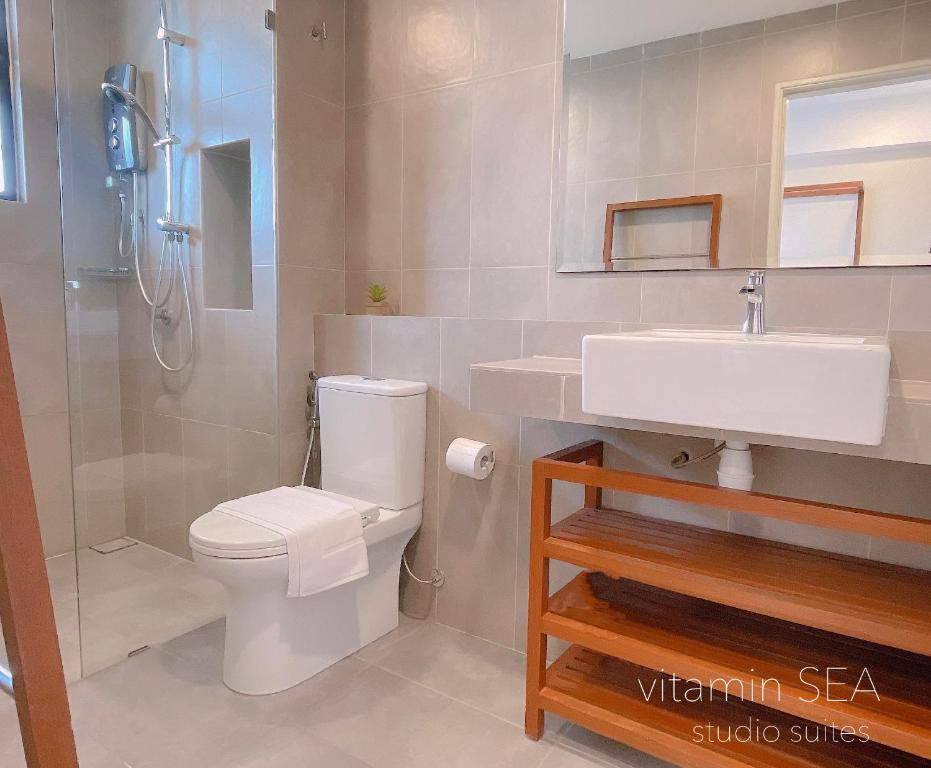 a bathroom with a toilet and a sink and a shower at vitamin SEA Timurbay Residence in Kuantan