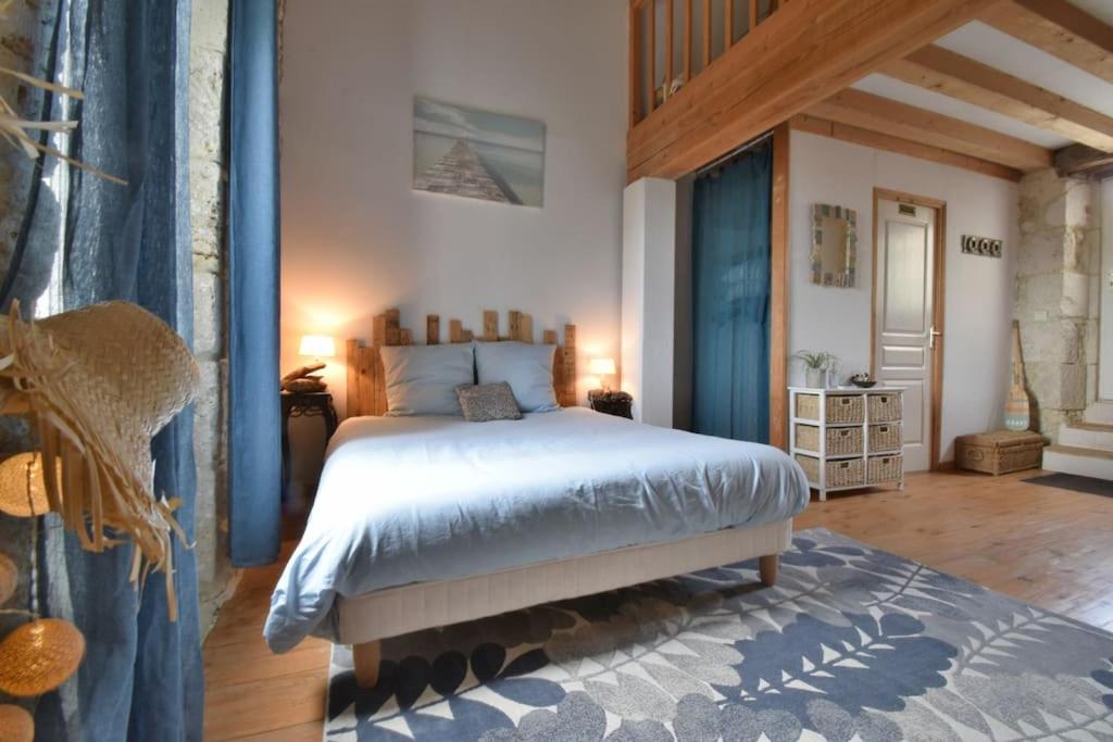a bedroom with a large bed in a room at Chambre d'hôtes Le Bol d'Air avec jacuzzi in Castelnau-sur-lʼAuvignon