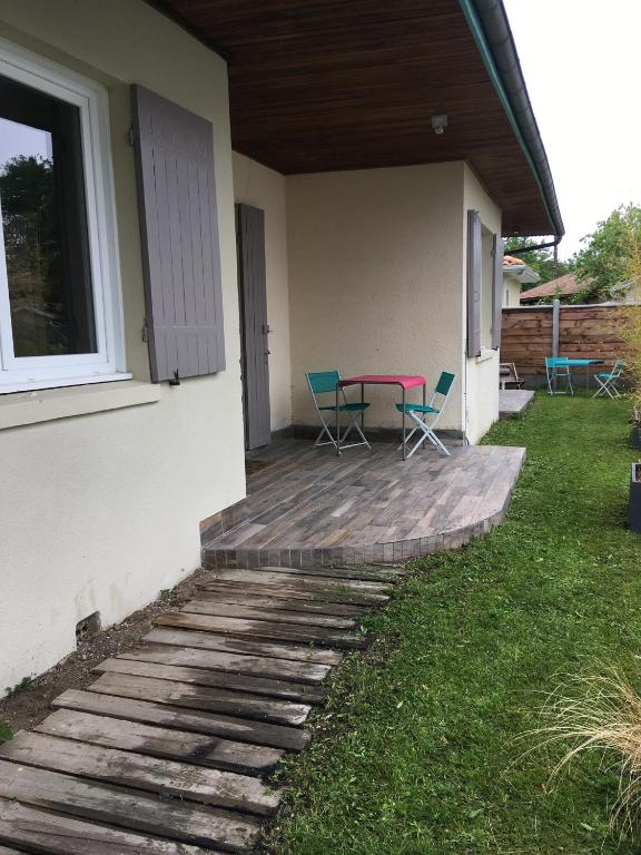 un patio con sillas y una mesa en una casa en Charmant séjour à Andernos, en Andernos-les-Bains