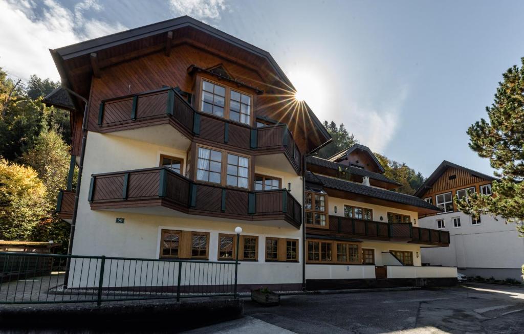 an apartment building with a wooden roof at Appartements Planai by Schladmingurlaub in Schladming