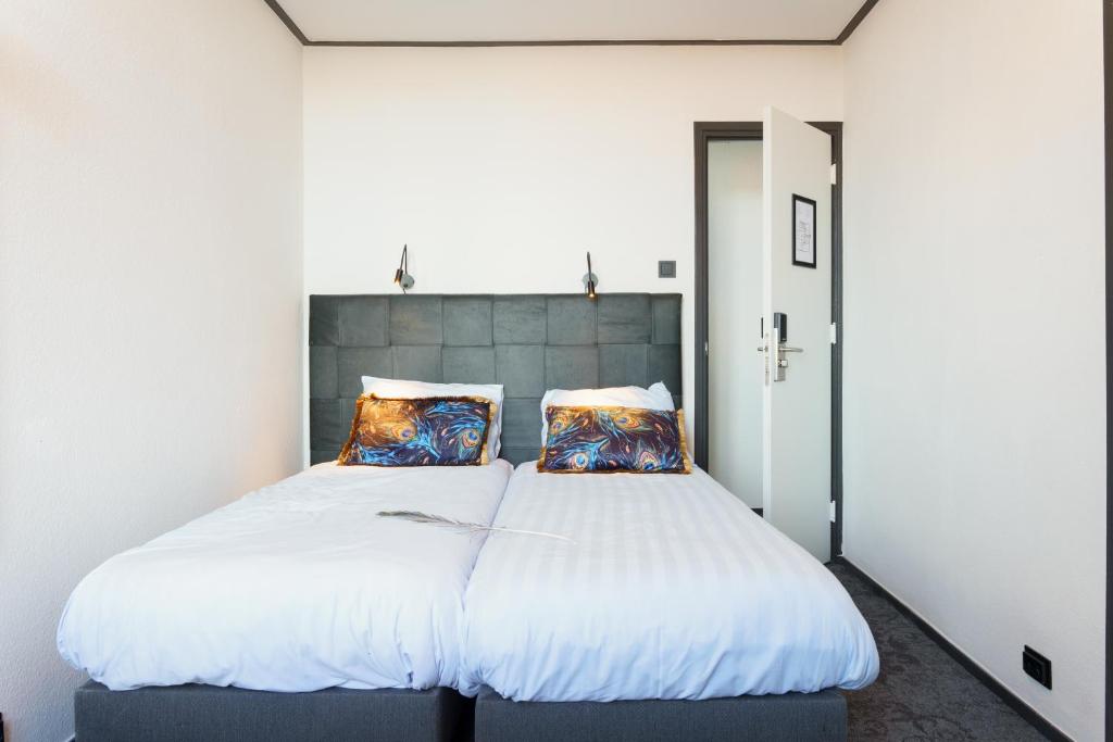 Postel nebo postele na pokoji v ubytování Hotel Pauw