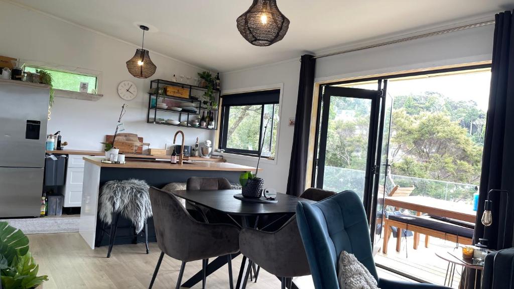 a kitchen and living room with a table and chairs at Paihia Central Apartments in Paihia
