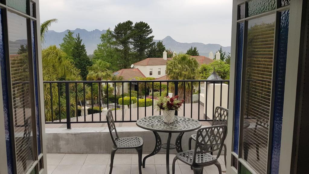 a table and chairs on a balcony with a view at Mountain View Self-Catering Apartment in Somerset West