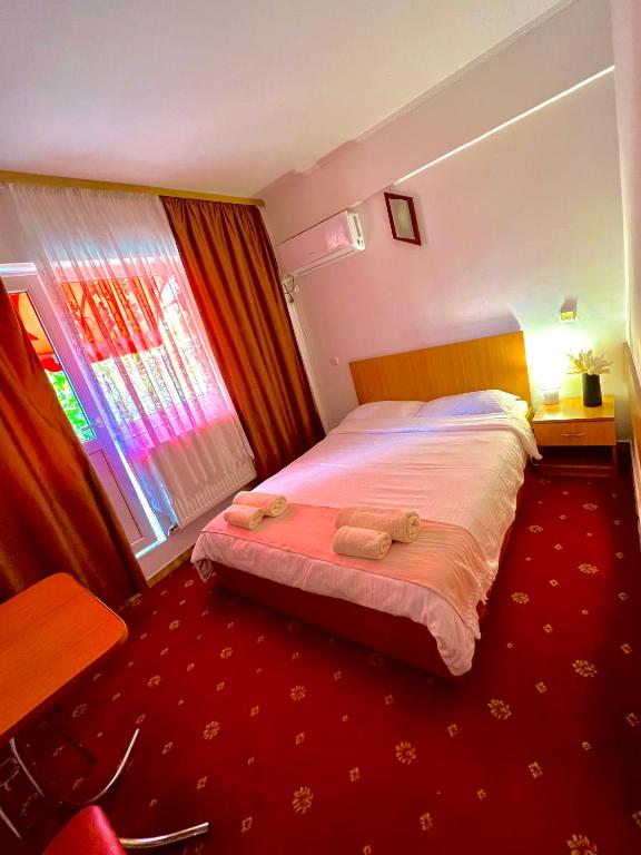 a bedroom with a bed with two towels on it at Sofia in Călăraşi