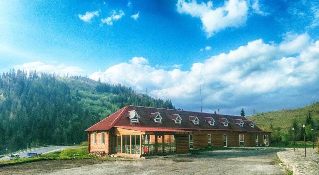 a large building with a red roof on a mountain at Dream Forest in Tukholʼka
