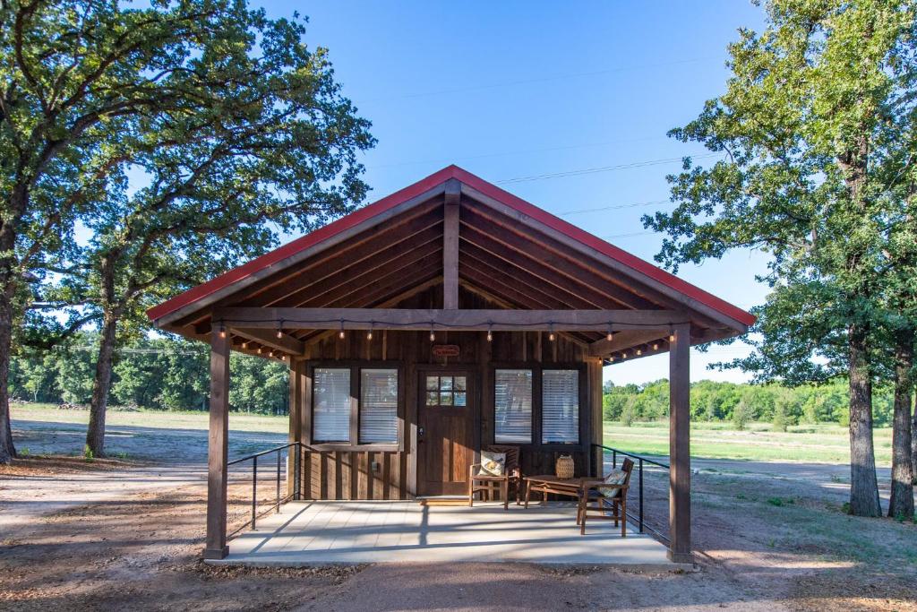 a gazebo in a park with trees in the background at The Bobwhite Cabin 15MIN to Magnolia Baylor 
