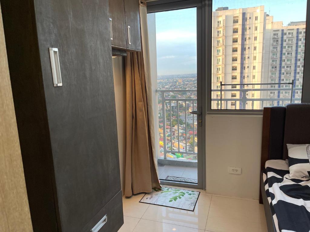 a bedroom with a large window with a view of a city at relaxing city view in Manila