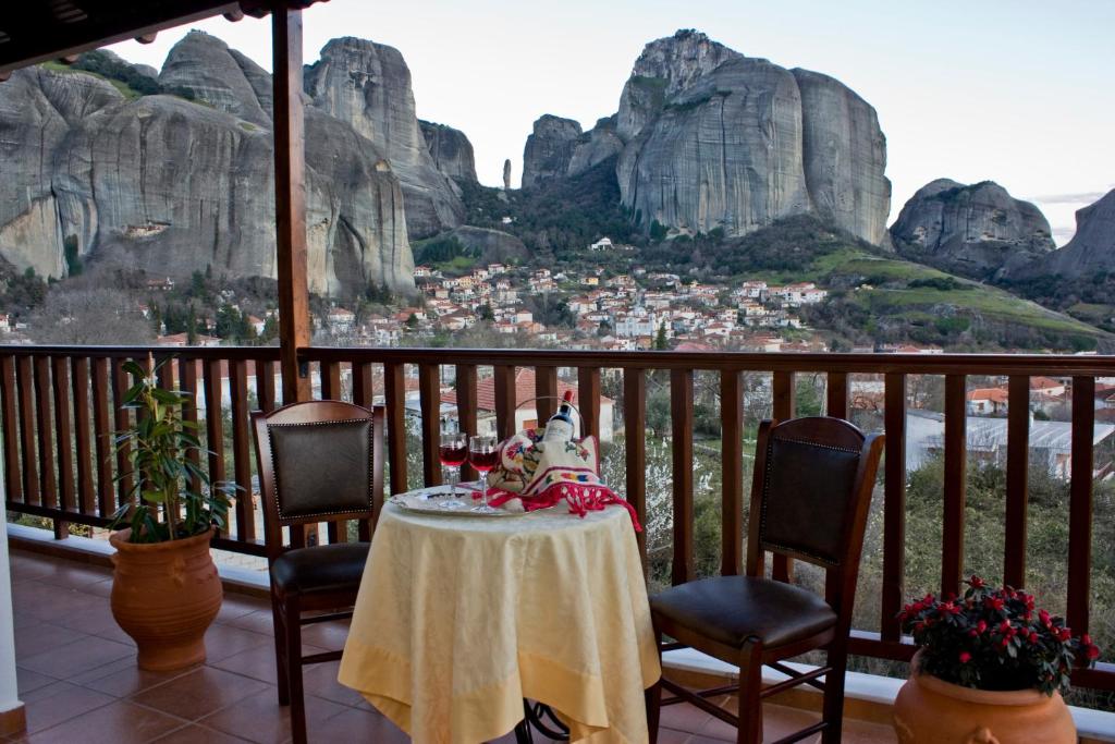 uma mesa numa varanda com vista para as montanhas em Hotel Doupiani House em Kalabaka