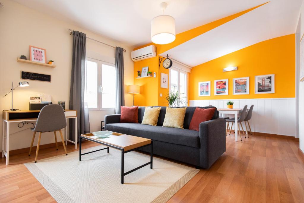 a living room with a couch and a table at Ático Teatro Romano - Terraza - Ascensor in Zaragoza