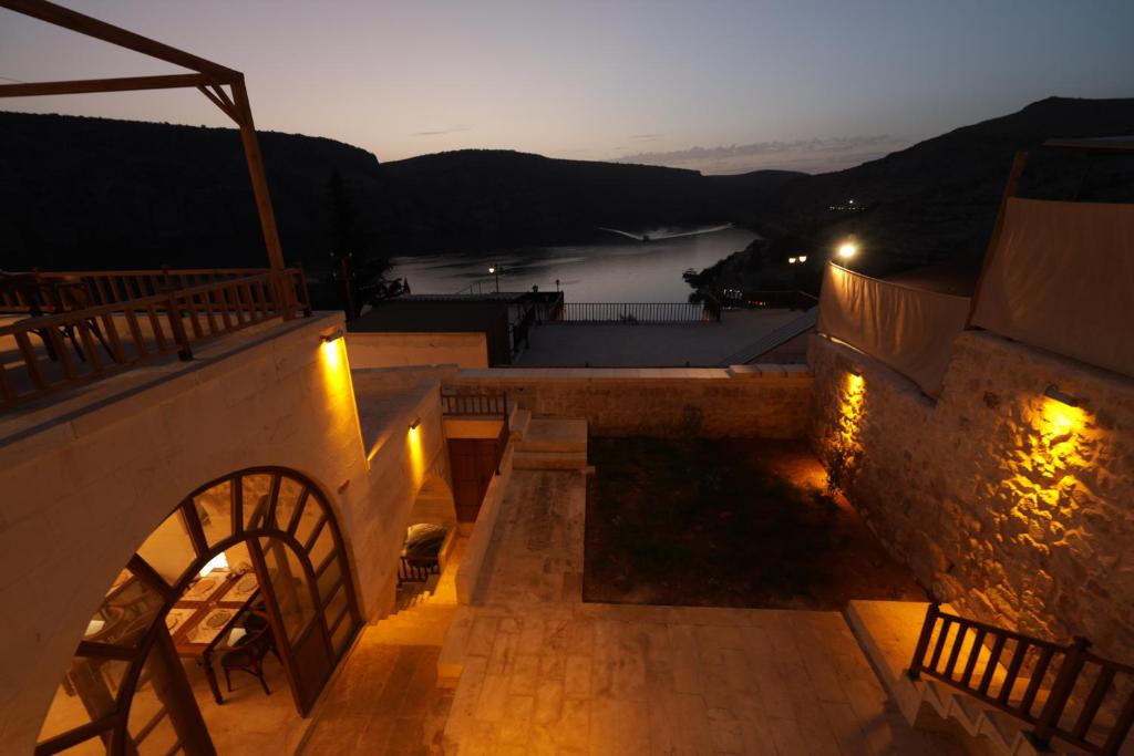 a set of stairs leading up to a building at night at CEVHER KONAĞI in Halfeti