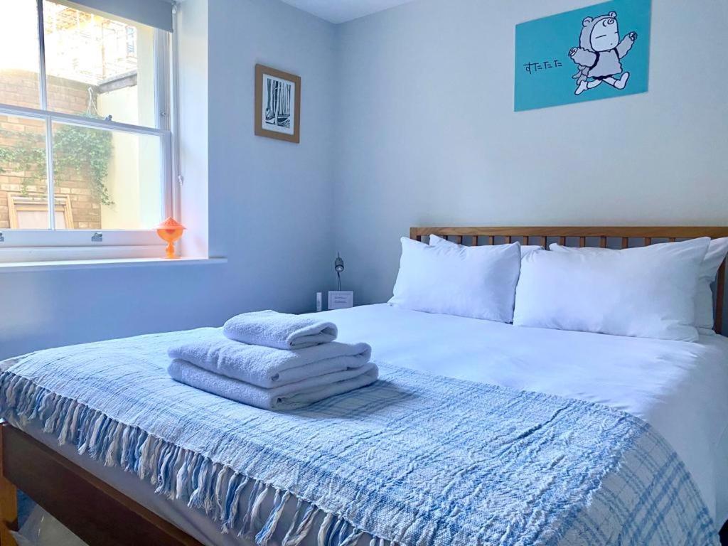 a bedroom with a bed with towels on it at No.2 Folkestone in Folkestone