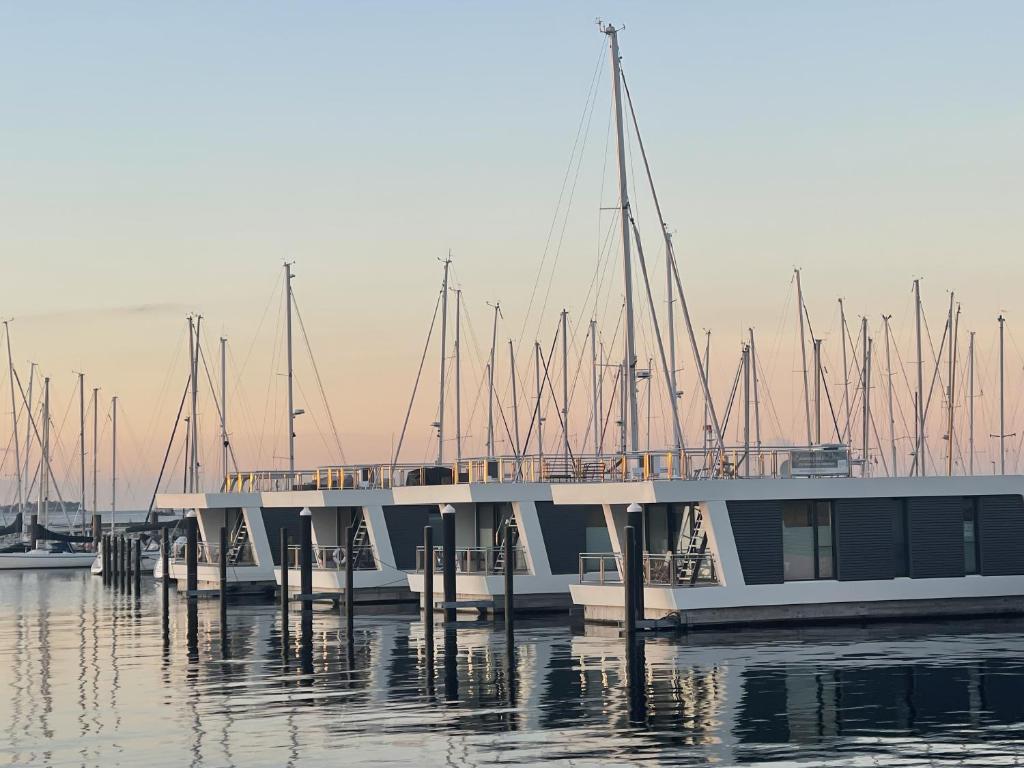 eine Gruppe von im Wasser angedockten Booten in der Unterkunft Floating Home Nr 1 in Laboe